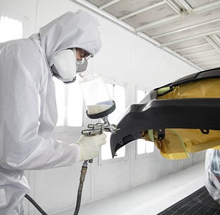 Collision Center Technician Painting a Vehicle | Toyota of Allentown in Allentown PA